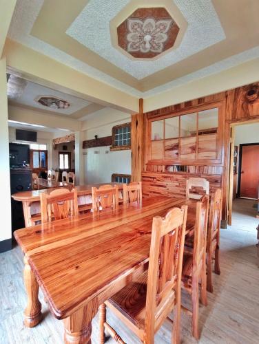 a dining room with a large wooden table and chairs at Sagada Staycation with Mountain View - 1st Floor in Sagada