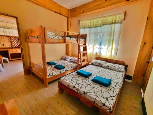 a room with two bunk beds in a house at Sagada Staycation with Mountain View - 1st Floor in Sagada