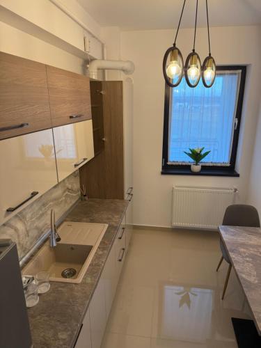 a kitchen with a sink and a window at Day Studio in Focşani