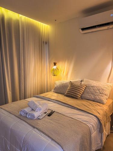 a bedroom with a large bed with towels on it at Casa Vista Mar - Praia do Frances in Marechal Deodoro