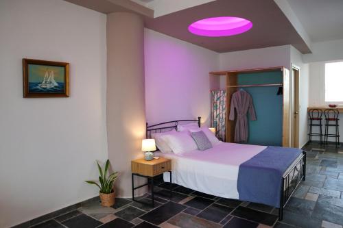 a bedroom with a bed with a pink ceiling at Seascape Apartment with Private Balcony in Faliraki in Faliraki