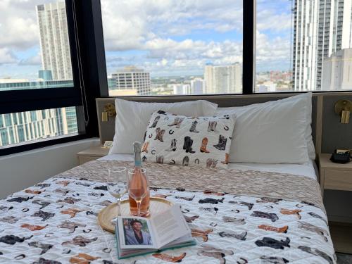 a bedroom with a bed with a book and a magazine at District 225 in Miami
