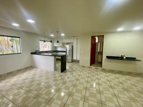 an empty living room with a kitchen and a counter at Casa Centro do Rio in Rio de Janeiro