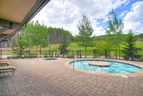 a swimming pool in a patio with a fence at Crystal Peak Lodge, A Vail Resorts Property in Breckenridge