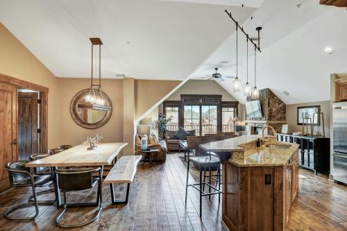 a kitchen and living room with a table and chairs at Crystal Peak Lodge, A Vail Resorts Property in Breckenridge