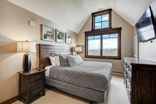 a bedroom with a bed and a tv and a window at Crystal Peak Lodge, A Vail Resorts Property in Breckenridge