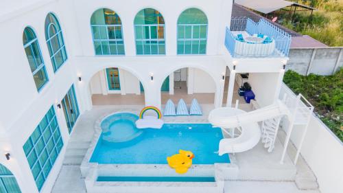 an aerial view of a house with a swimming pool at Blue Tierra Pool Villa Pattaya in Ban Hua Phrong
