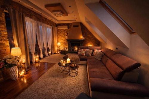 a living room with a couch and a table at Spa Residence beltéri jakuzzi inside jakuzzi in Veszprémfajsz