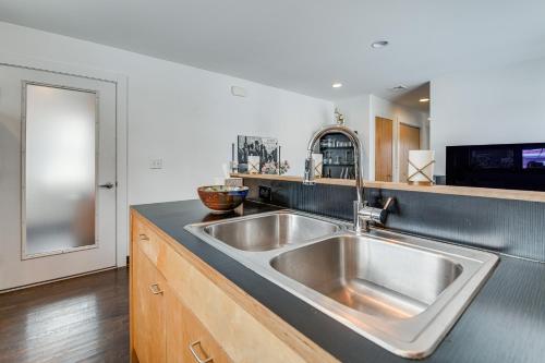 a kitchen with a large stainless steel sink at Couple’s Retreat Near UVM! Unique Studio w/ Deck in Burlington