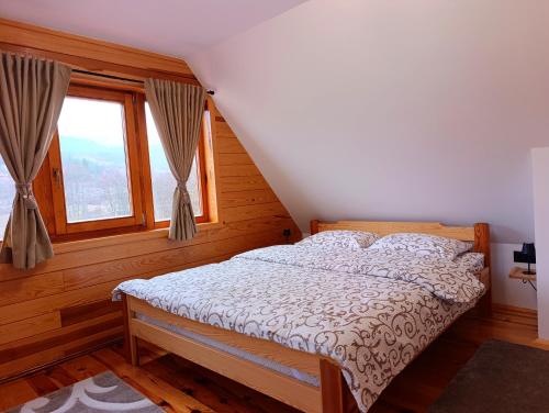 a bedroom with a bed and a window at Vila Sofija Mokra Gora in Mokra Gora