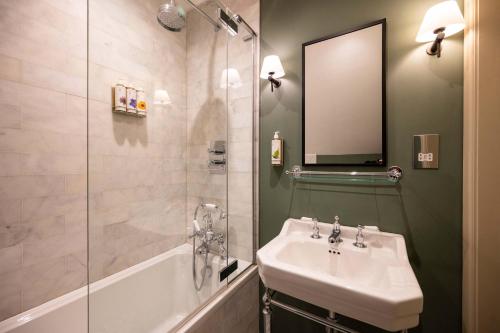 a bathroom with a sink and a shower and a mirror at The Bottle & Glass Inn - Barn View - Room 2 in Henley on Thames