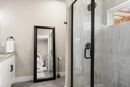 a bathroom with a shower with a glass door at NEW Stunning Views & Lake Access Villa in Granbury