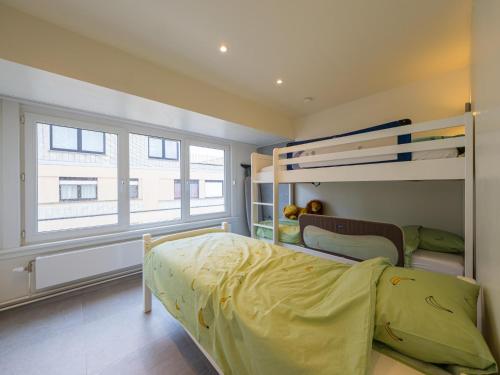 a bedroom with a bunk bed and a window at Trianon - 0609 in Westende-Bad