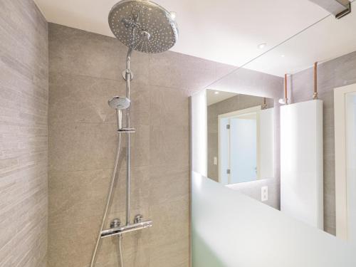 a shower in a bathroom with a mirror at Trianon - 0609 in Westende-Bad