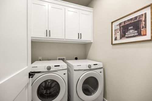 a white laundry room with a washer and dryer at NEW Stunning Views & Lake Access Villa in Granbury