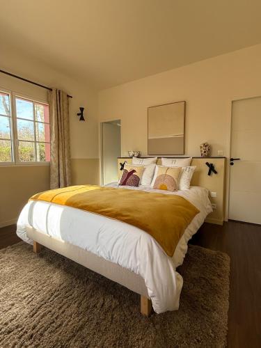 a bedroom with a large bed and a window at Maison d'Hôtes HAITZ TEYA - La Chênaie in Ascain