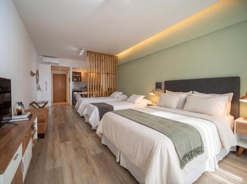 a hotel room with two beds and a television at iDeal Concord Pilar Aparts in Pilar