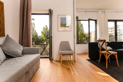 a living room with a couch and a chair at Center Gardens Apartments in Lisbon