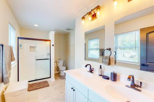 a bathroom with two sinks and a toilet at Indy Home w/ Dog-Friendly Yard! 9 Mi to Dtwn in Spring Hollow