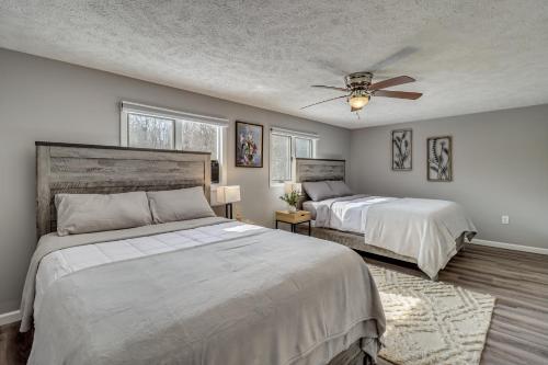 a bedroom with two beds and a ceiling fan at Contemporary House in Lakeside Community! Poconos in Albrightsville