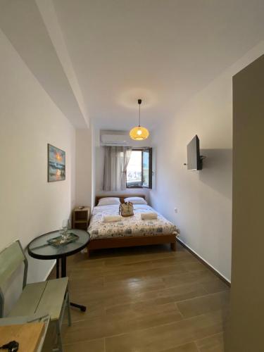 a bedroom with a bed and a glass table at Mare Studio by All Around in Heraklio