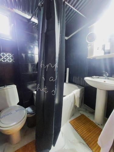 a bathroom with a toilet and a tub and a sink at jim villa family apartment with private yard andravida-kyllini in Andravída