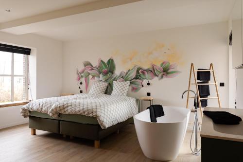 a bedroom with a bed and a painting on the wall at Vakantiehoeve Breathe Nature in Lochristi