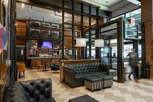 a lobby with a couch and a bar at Archer Hotel New York in New York