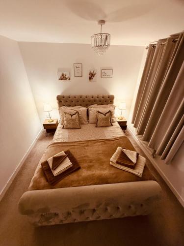 a bedroom with a large bed with two pillows at Gloria's Getaway in Langport