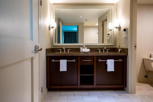 a bathroom with a sink and a mirror at Gold Strike Casino Resort in Tunica Resorts