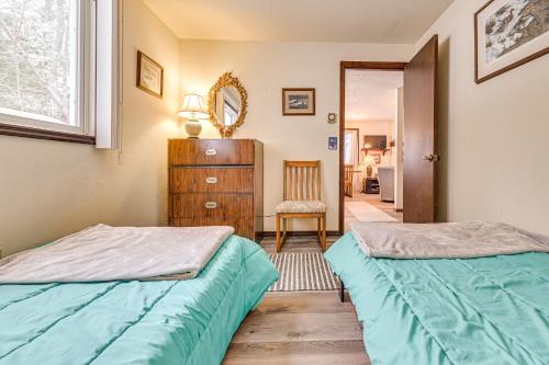 a bedroom with two beds and a dresser at 3 Mi to Windham Mountain: Pet-Friendly Apt w/ Yard in Hensonville