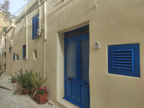 a blue door on the side of a building at SeaFront Apartment In Valletta in Valletta