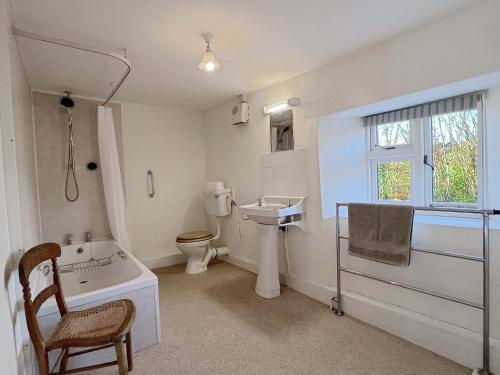 a bathroom with a sink and a toilet and a tub at Brightworthy Farm Withypool in Withypool