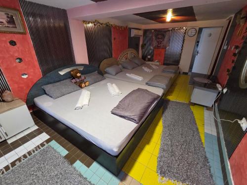 a large bed with a teddy bear sitting on top of it at vila darkoni in Bijeljina