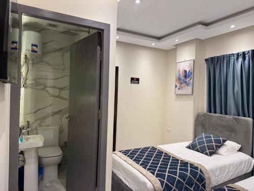 a small bathroom with a bed and a sink at Colour holiday Zayed in Sheikh Zayed