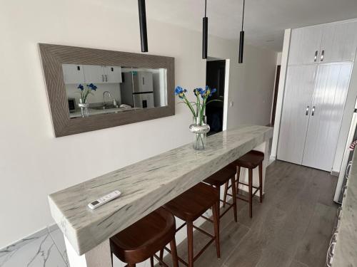 a kitchen with a long table with chairs and a mirror at 2BR Condo with Ocean View near beach in Bucerías