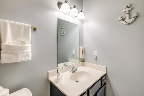 a white bathroom with a sink and a mirror at Surfboard-Themed Huddleston Studio w/ Beach Access in Huddleston
