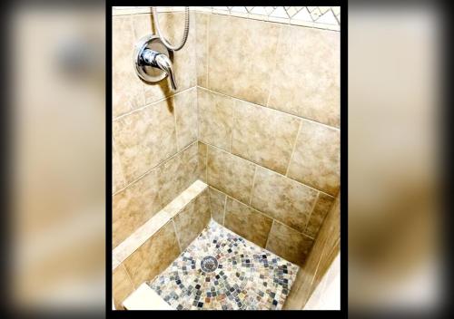 a bathroom with a shower with a tiled floor at Boutique Guest Suite Private Entrance Near Hard Rock FLL Airport Cruise Port in Fort Lauderdale
