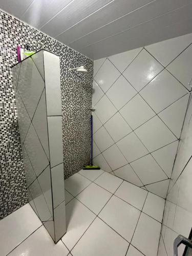 a bathroom with a shower with a glass door at Casa brisa do mar icapuí in Icapuí