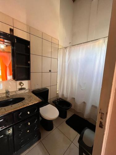 a small bathroom with a toilet and a sink at Damaris Hostel in Puerto Iguazú