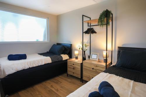 a bedroom with two beds and a window at Penrhos Walks in Holyhead