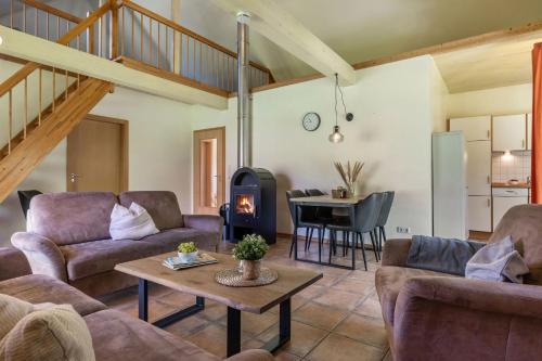 a living room with couches and a wood stove at Ferienhaus 4 in Fehmarn