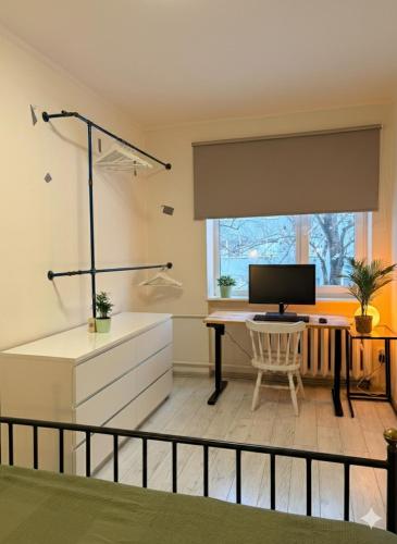 a room with a desk with a computer on it at Nice apartment close to the beach in Tallinn