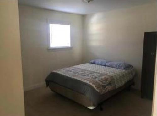 a small bedroom with a bed with a window at Caribbean Deck Estate in Effort