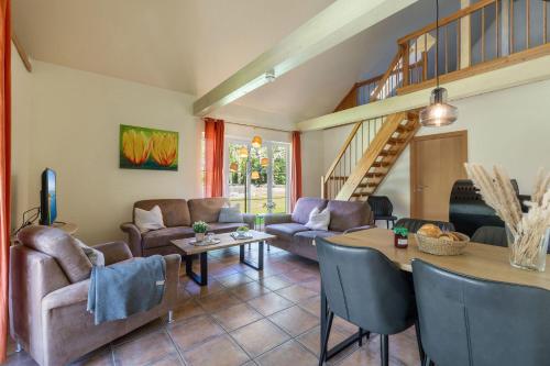 a living room with a couch and a table at Ferienhaus 3 in Fehmarn