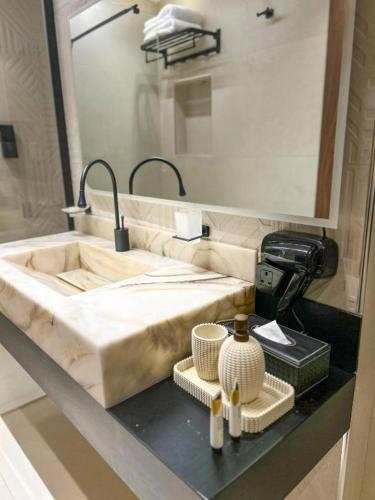 a bathroom counter with a sink and a mirror at فلل خاصة في آي بي فاخرة - فندق وأبراج مكة in Mecca