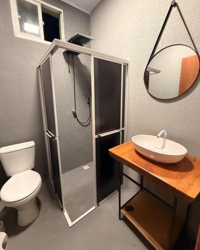 a bathroom with a shower and a toilet and a sink at Hostel em Jaguarão in Jaguarão
