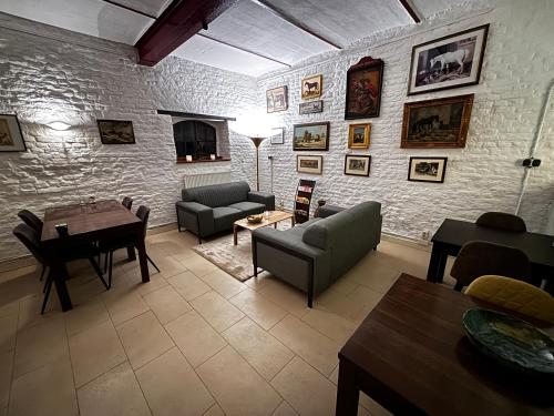 a living room with a couch and a table at B&B en Vakantiewoningen 't Wienhoes in Wittem