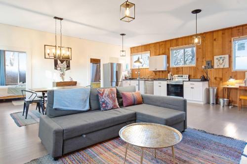 a living room with a couch and a kitchen at Central Bench Garden Guest House in Boise