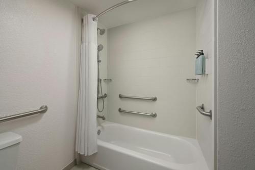 a bathroom with a shower and a bath tub at Residence Inn Phoenix Mesa in Mesa